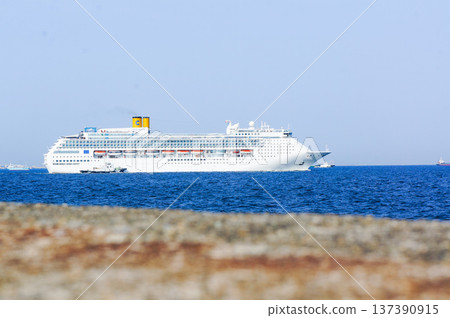 Profile of a luxury cruise ship sailing under the blue sky Profile of a luxury cruise ship sailing under the blue sky 137390915
