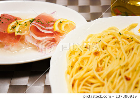 A stylish Italian dinner with peperoncino and prosciutto appetizers A stylish Italian dinner with peperoncino and prosciutto appetizers 137390919