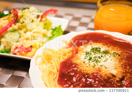 A hearty lunch of spaghetti with meat sauce and potato salad 137390921