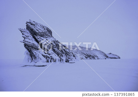 Spectacular landscape of the Dragon tail rock while snowing located at Ogoy island in frozen lake Baikal in winter season. Lake Baikal is the world's deepest lake located in southern Siberia, Russia. Spectacular landscape of the Dragon tail rock while snowing located at Ogoy island in frozen lake Baikal in winter season. Lake Baikal is the world's deepest lake located in southern Siberia, Russia. 137391865