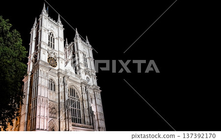 Historic gothic cathedral architecture illuminated at night under a dramatic sky, highlighting intricate stone design and timeless European heritage. Historic gothic cathedral architecture illuminated at night under a dramatic sky, highlighting intricate stone design and timeless European heritage. 137392170