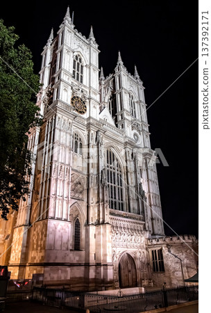 Historic gothic cathedral architecture illuminated at night under a dramatic sky, highlighting intricate stone design and timeless European heritage. Historic gothic cathedral architecture illuminated at night under a dramatic sky, highlighting intricate stone design and timeless European heritage. 137392171
