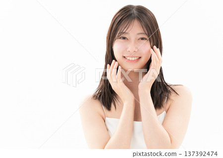 Beauty image of a woman doing skin care on a white background Beauty image of a woman doing skin care on a white background 137392474