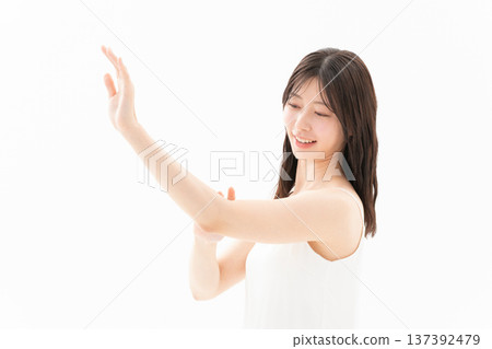 Beauty image of a woman doing skin care on a white background Beauty image of a woman doing skin care on a white background 137392479