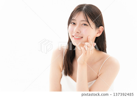 Beauty image of a woman doing skin care on a white background 137392485