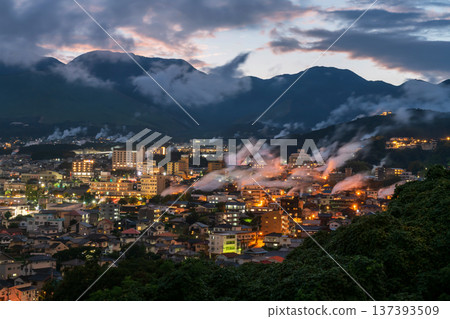 Beppu town with smoke of hot spring bath ryokan at dusk, Oita Beppu town with smoke of hot spring bath ryokan at dusk, Oita 137393509
