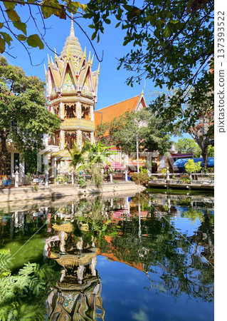 Bell tower building with skyline reflection on pond at Wat Pho, Korat Bell tower building with skyline reflection on pond at Wat Pho, Korat 137393522