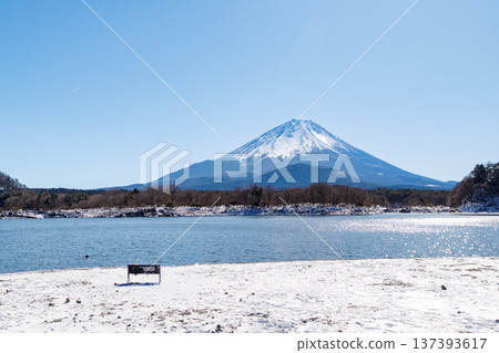 Early spring scenery of Lake Shoji: Mount Fuji embracing its child seen through the frozen lake surface, Yamanashi Prefecture Early spring scenery of Lake Shoji: Mount Fuji embracing its child seen through the frozen lake surface, Yamanashi Prefecture 137393617