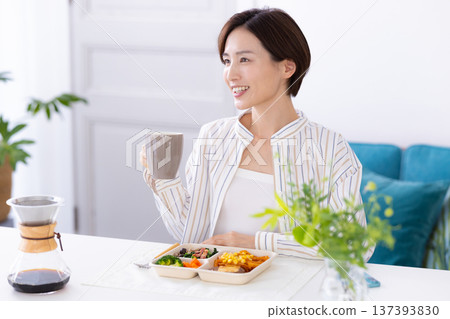 Meal: Woman eating a delivery lunch Meal: Woman eating a delivery lunch 137393830