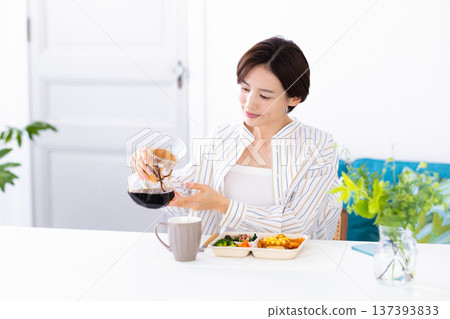 Meal: Woman eating a delivery lunch Meal: Woman eating a delivery lunch 137393833