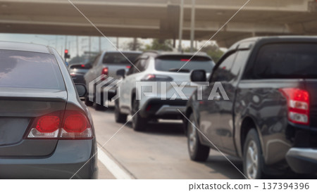 Rear side of many cars stop on concrete road by traffic light control. Front of road with concrete bright and traffic red light under blue sky. Rear side of many cars stop on concrete road by traffic light control. Front of road with concrete bright and traffic red light under blue sky. 137394396