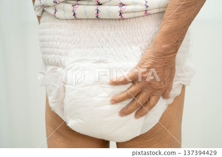 Asian senior woman patient wearing adult incontinence diaper pad in hospital. Asian senior woman patient wearing adult incontinence diaper pad in hospital. 137394429