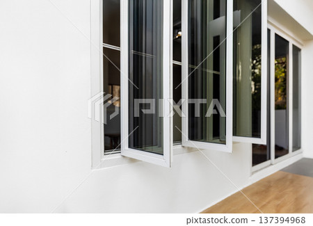 Three panel aluminium casement window stay on white wall. Three panel aluminium casement window stay on white wall. 137394968