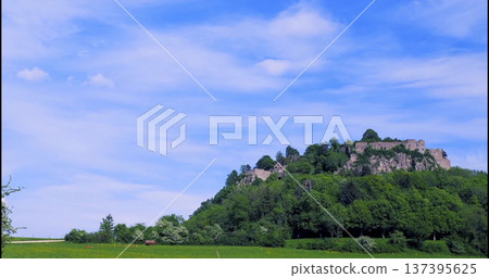 Castle sits on a hill with trees and blue sky in the background during daytime Castle sits on a hill with trees and blue sky in the background during daytime 137395625