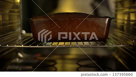 Baking a cake in the oven on a warm afternoon at home with family 137395660