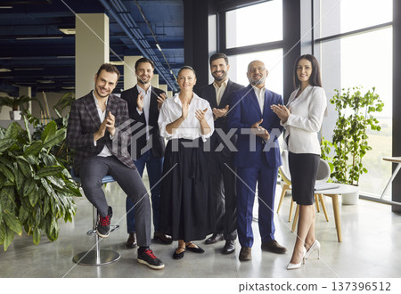 Happy business team clapping hands, smiling on meeting in open space office Happy business team clapping hands, smiling on meeting in open space office 137396512