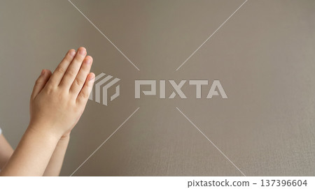 Child Praying with Hands Together on Neutral Background 137396604