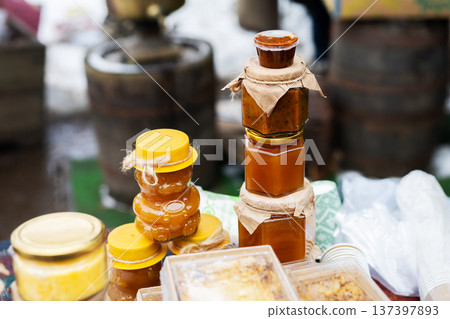 Rustic market with honey and preserves. Vibrant stall showcasing honey and homemade goods 137397893