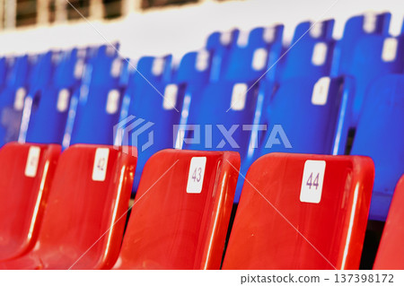 Empty seats in a stadium, close-up. Blue and red seats Empty seats in a stadium, close-up. Blue and red seats 137398172