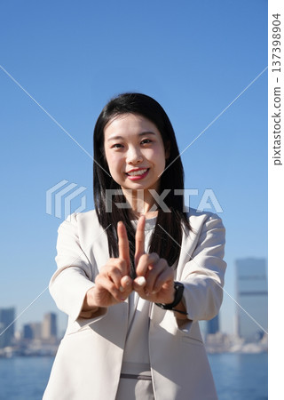 A young woman in a suit using sign language A young woman in a suit using sign language 137398904