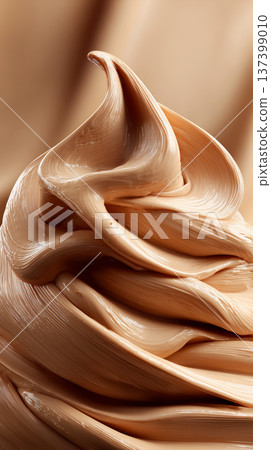 Closeup of smooth, thick, wavy beige cream swirls on soft background showing luxury texture concept of a liquid foundation Closeup of smooth, thick, wavy beige cream swirls on soft background showing luxury texture concept of a liquid foundation 137399010