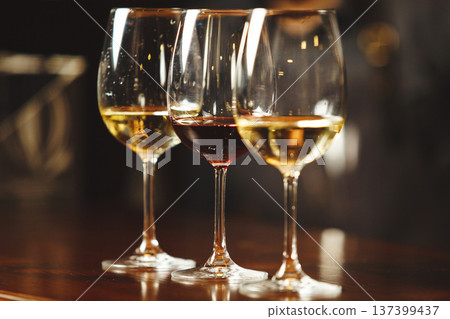 Glasses of white and red wine on bar counter Glasses of white and red wine on bar counter 137399437