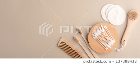 Eco-friendly bathroom essentials, bamboo toothbrushes, cotton swabs, reusable cotton pads, comb, facial brush. Green lifestyle, eco-consciousness 137399438