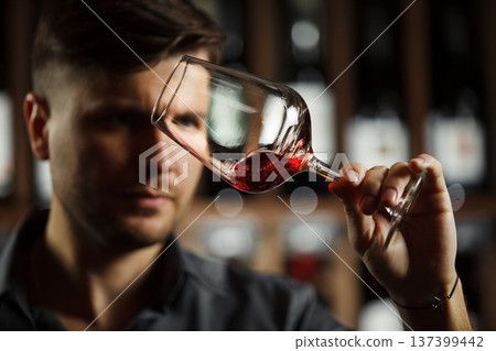 Bokal of red wine on background, male sommelier appreciating drink Bokal of red wine on background, male sommelier appreciating drink 137399442