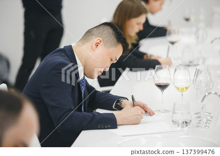 Sommelier examination to get certificate professional work of winemaking. Blind wine tasting. Sommelier degustate wine. Sommelier examination to get certificate professional work of winemaking. Blind wine tasting. Sommelier degustate wine. 137399476