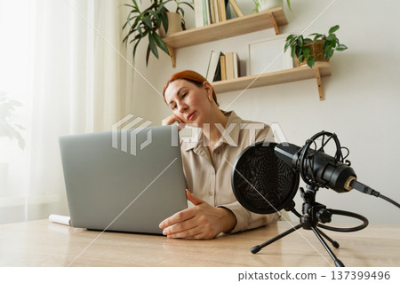 Woman recording podcast at home studio. A popular psychologist blogger on social media holds a video meeting on his channel Woman recording podcast at home studio. A popular psychologist blogger on social media holds a video meeting on his channel 137399496