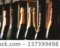 Underground cellar with elite sparkling wine on shelves, close up horizontal photo. 137399498