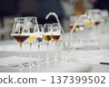 Various alcoholic beverages in glasses in white table in wine room. Sommelier school, professional certification, winemaking association. 137399502