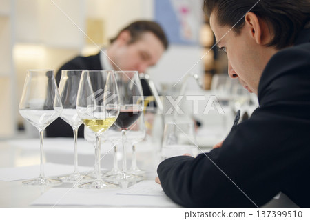 Sommelier degustate wine. Training of restaurant staff, studying alcohol list. Blind wine tasting. 137399510