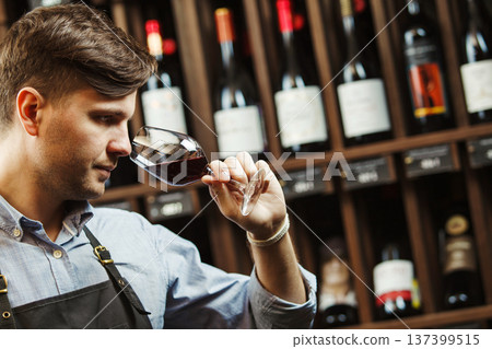 Bokal of red wine on background, male sommelier appreciating drink Bokal of red wine on background, male sommelier appreciating drink 137399515