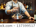Bartender decanting wine without disturbing the sediment 137399517