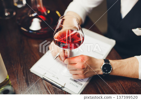 Degustation process with glassware, decanter on table. 137399520