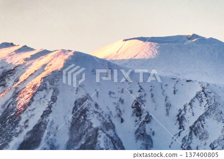 The setting sun shines on Mount Iwate, also known as the Southern Half of Fuji. The setting sun shines on Mount Iwate, also known as the Southern Half of Fuji. 137400805