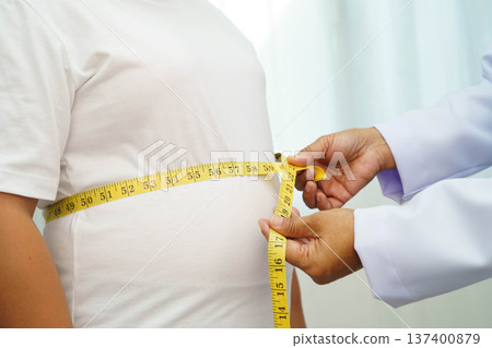 Asian woman with fat belly big size overweight and obesity with measure tape. 137400879