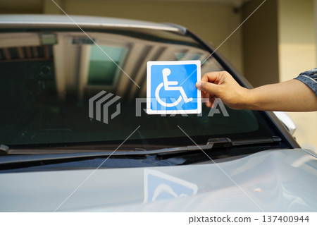 Wheelchair sticker sign on car for safety travel. 137400944
