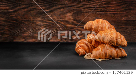 Fresh Croissants Stack on Rustic Wooden Background 137401129