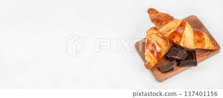 Fresh Croissants with Dark Chocolate on Wooden Board Fresh Croissants with Dark Chocolate on Wooden Board 137401156