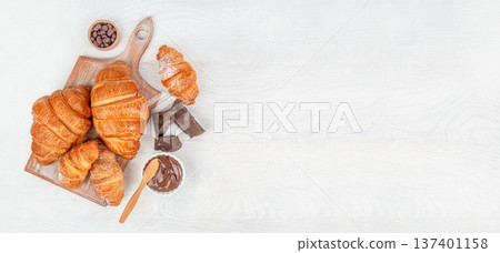 Croissants with Chocolate and Spread on Wooden Board Top View Croissants with Chocolate and Spread on Wooden Board Top View 137401158