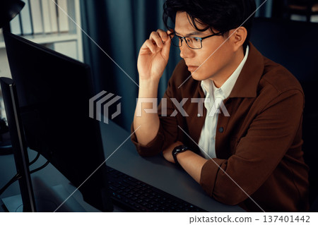 Businessman focusing computer business plan report over late night. Infobahn. Businessman focusing computer business plan report over late night. Infobahn. 137401442