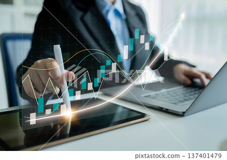 Business Professional Analyzing Financial Data with Tablet and Laptop in Modern Office Setting, Analyzing Growth Trends and Market Patterns Impute Business Professional Analyzing Financial Data with Tablet and Laptop in Modern Office Setting, Analyzing Growth Trends and Market Patterns Impute 137401479