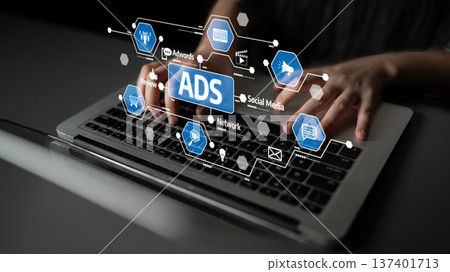 Hands Typing on Laptop Keyboard with Digital Overlay of Advertising Icons and Social Media Symbols Representing Online Marketing Concepts. Tessel Hands Typing on Laptop Keyboard with Digital Overlay of Advertising Icons and Social Media Symbols Representing Online Marketing Concepts. Tessel 137401713
