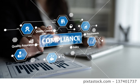 Professional business person analyzing compliance data with digital interface surrounded by icons for quality assurance, control, and requirements in a modern office. Tessel Professional business person analyzing compliance data with digital interface surrounded by icons for quality assurance, control, and requirements in a modern office. Tessel 137401737
