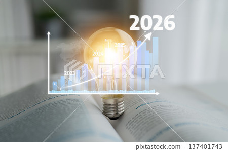 Conceptual Image of Light Bulb on Open Book with Growing Chart Representing Future Trends and Progression for Years 2023 to 2026. Tessel Conceptual Image of Light Bulb on Open Book with Growing Chart Representing Future Trends and Progression for Years 2023 to 2026. Tessel 137401743