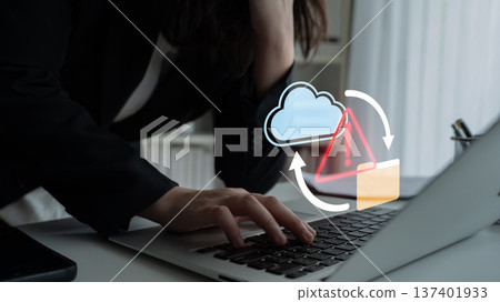 Business professional experiencing frustration with cloud data management while using a laptop in a modern workspace with warning symbols overlay Gantry Business professional experiencing frustration with cloud data management while using a laptop in a modern workspace with warning symbols overlay Gantry 137401933