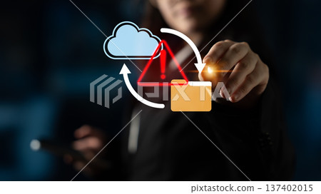 Business professional interacting with cloud technology symbols, including warning sign and folder icon representing data security and management risks Gantry 137402015
