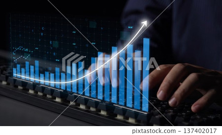 Professional hands working on a keyboard with a digital graph and rising trend line illustrating growth and analytics in a modern business environment Copula 137402017